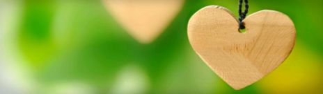 wooden-heart-on-green-background-header
